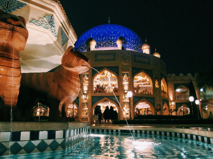 a sculpture of a cat sitting on top of a tiled pool