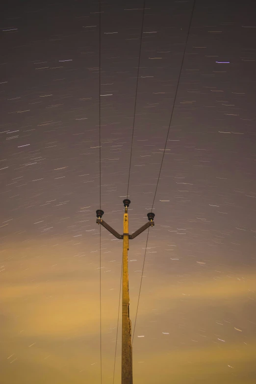 telephone wires with sky in the background at night