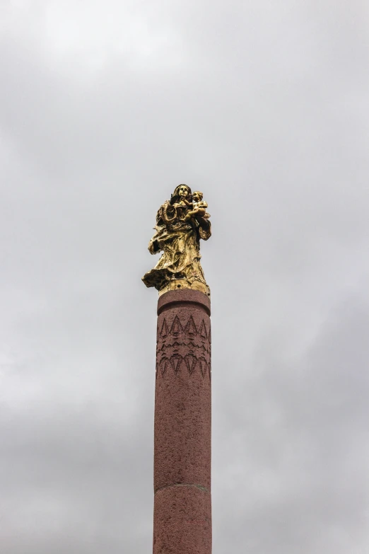 an image of a statue on top of a pillar