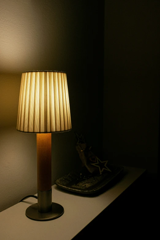 a lamp and a piece of wood on a table