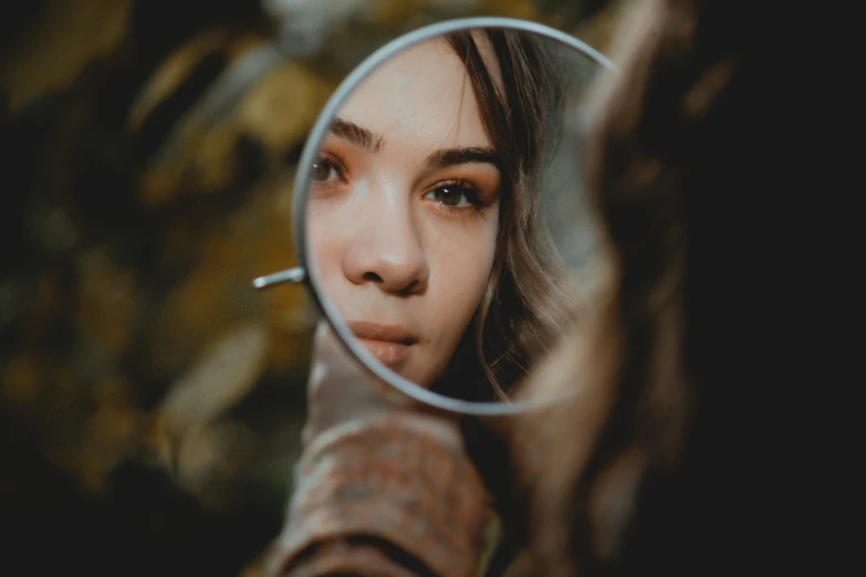 a woman looking through a magnifying glass at her skin