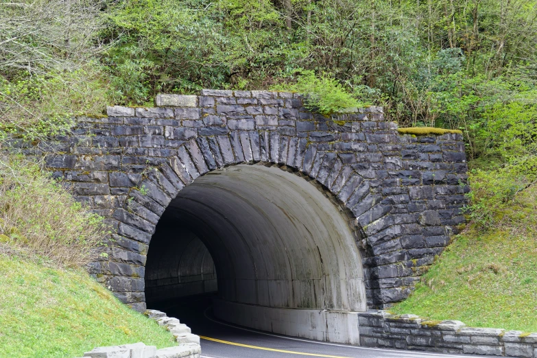 the light at the end of a dark tunnel has a small road under it