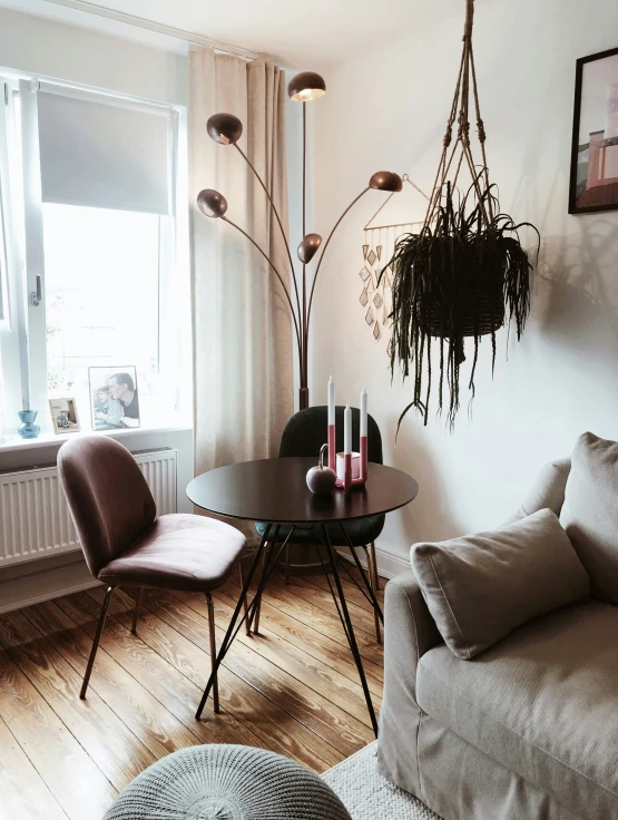 a living room is decorated with plants and sofas