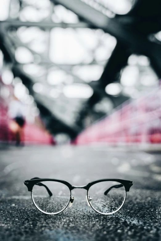 a pair of black glasses sits on the ground