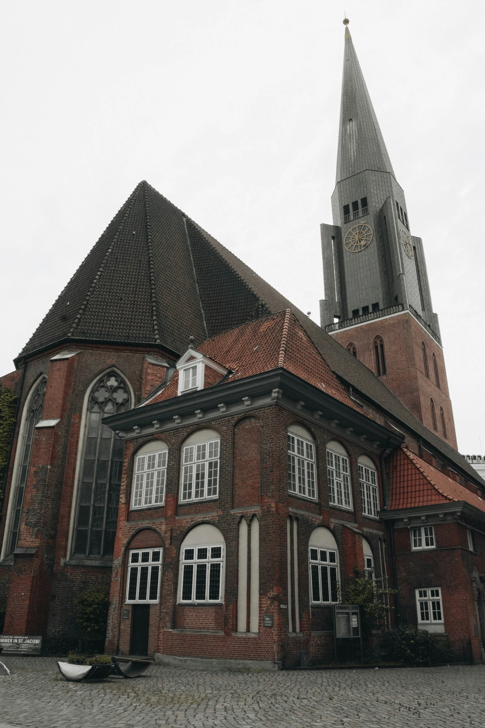 an old red brick church with the steeple above