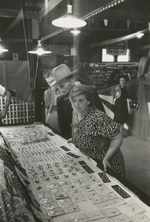two men and a woman are working on some type of item