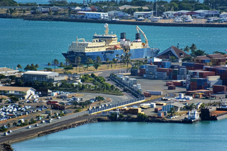 a view of the sea port with shipping ships and docked containers