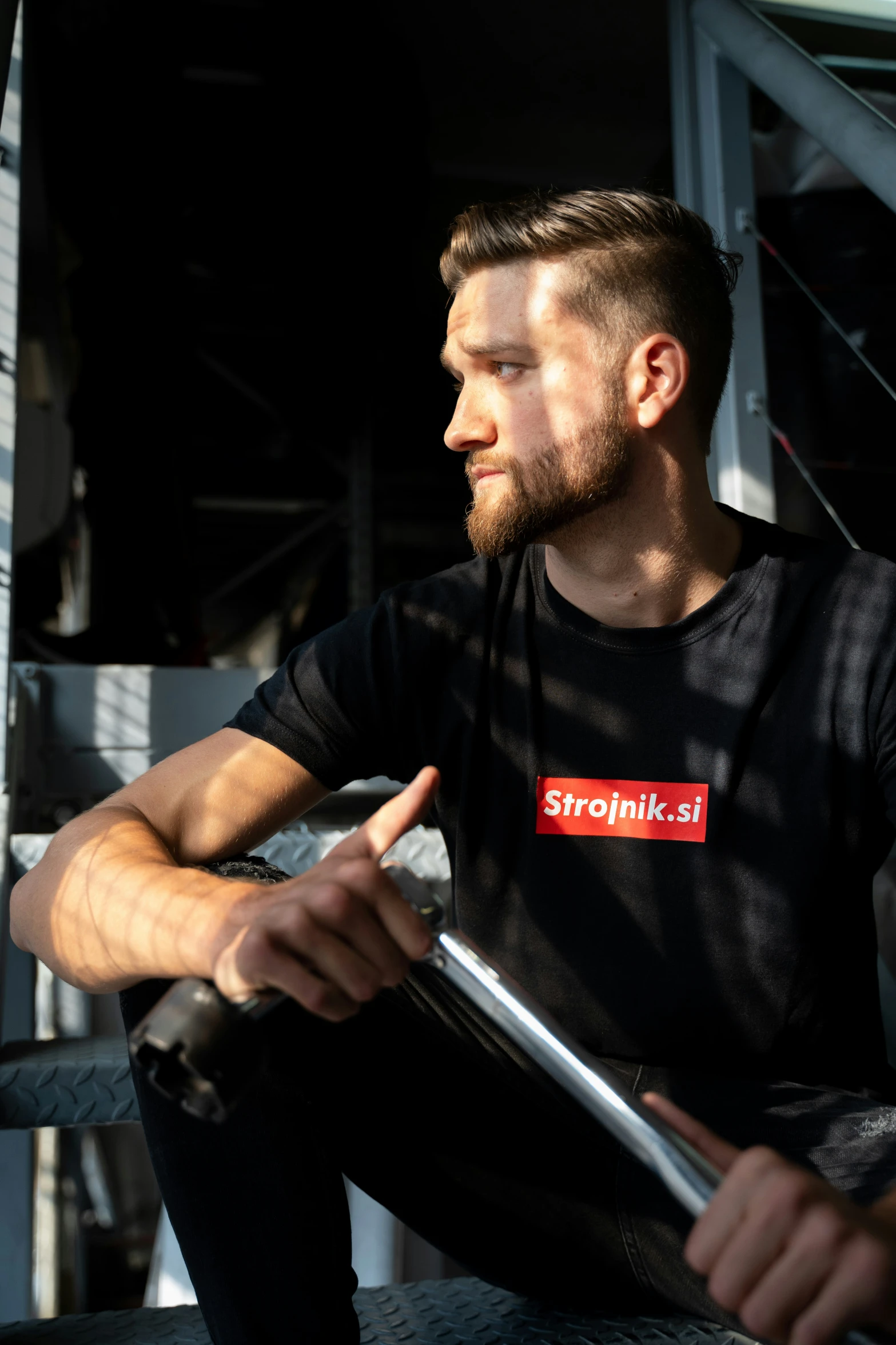 a man with short hair is sitting on steps