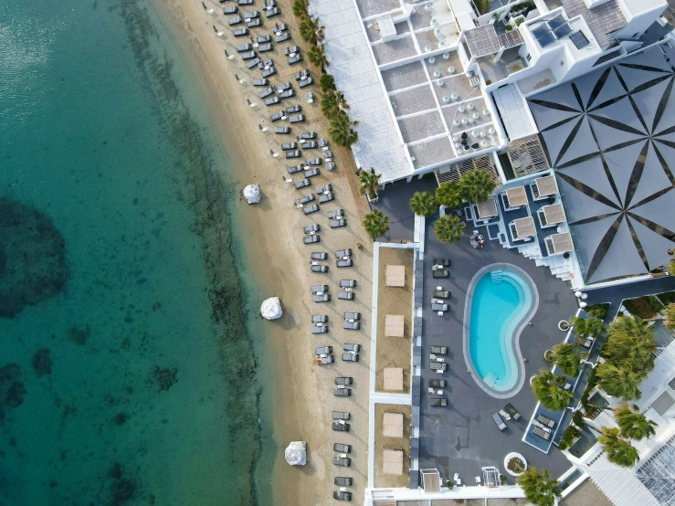 an aerial view of some boats sitting near some water