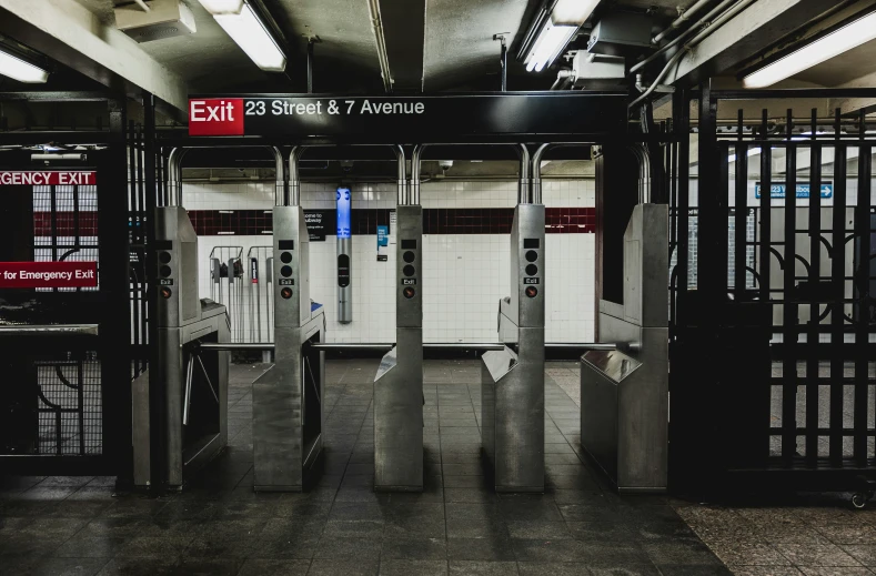 an empty subway station entrance with a few doors