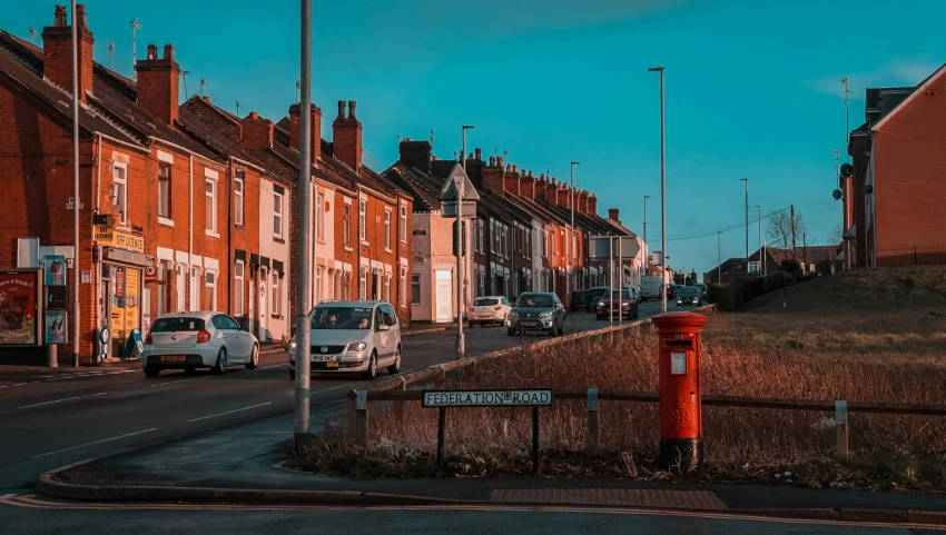 a line of red brick buildings on the side of the road