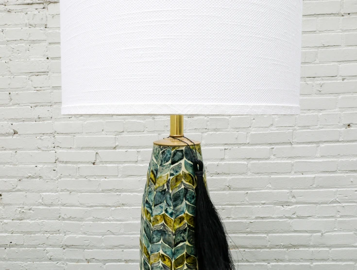 a lamp with a fabric shade, with a gold base