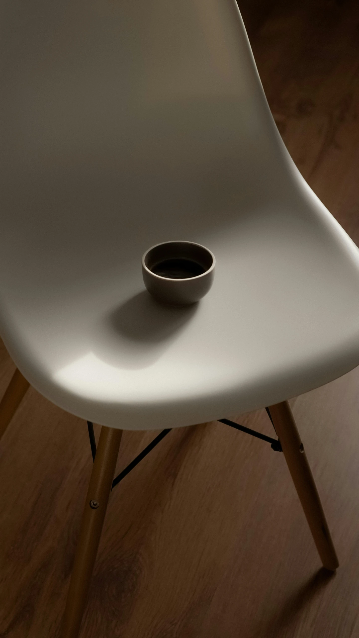 a white chair sitting on top of a hard wood floor