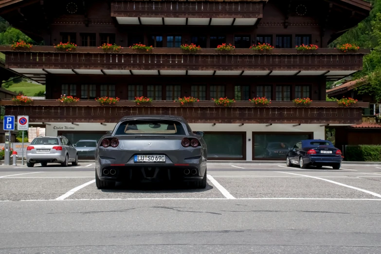 a silver car parked in front of an upscale building