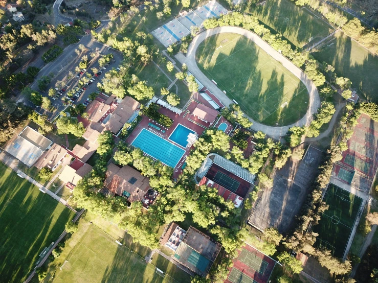 an aerial view of a tennis court and the surrounding surrounding buildings