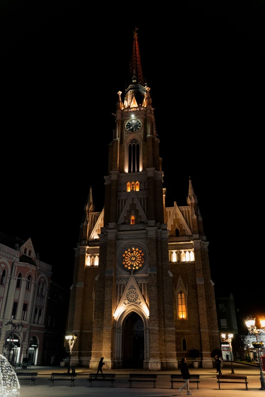 a tall building is lit up with christmas decorations