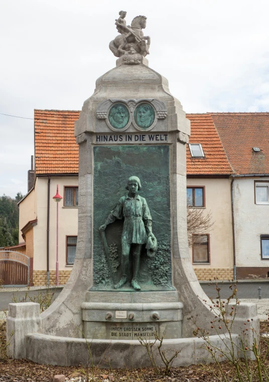 a monument has a statue of a man with an award for his work