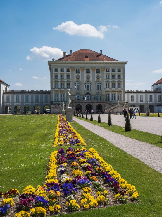 the view of a building with several flowers in front