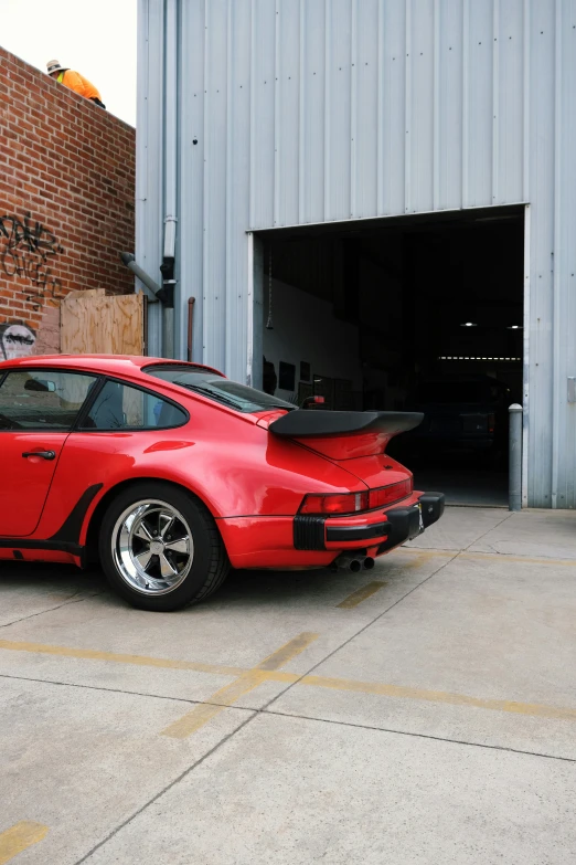 a red sports car parked in a garage