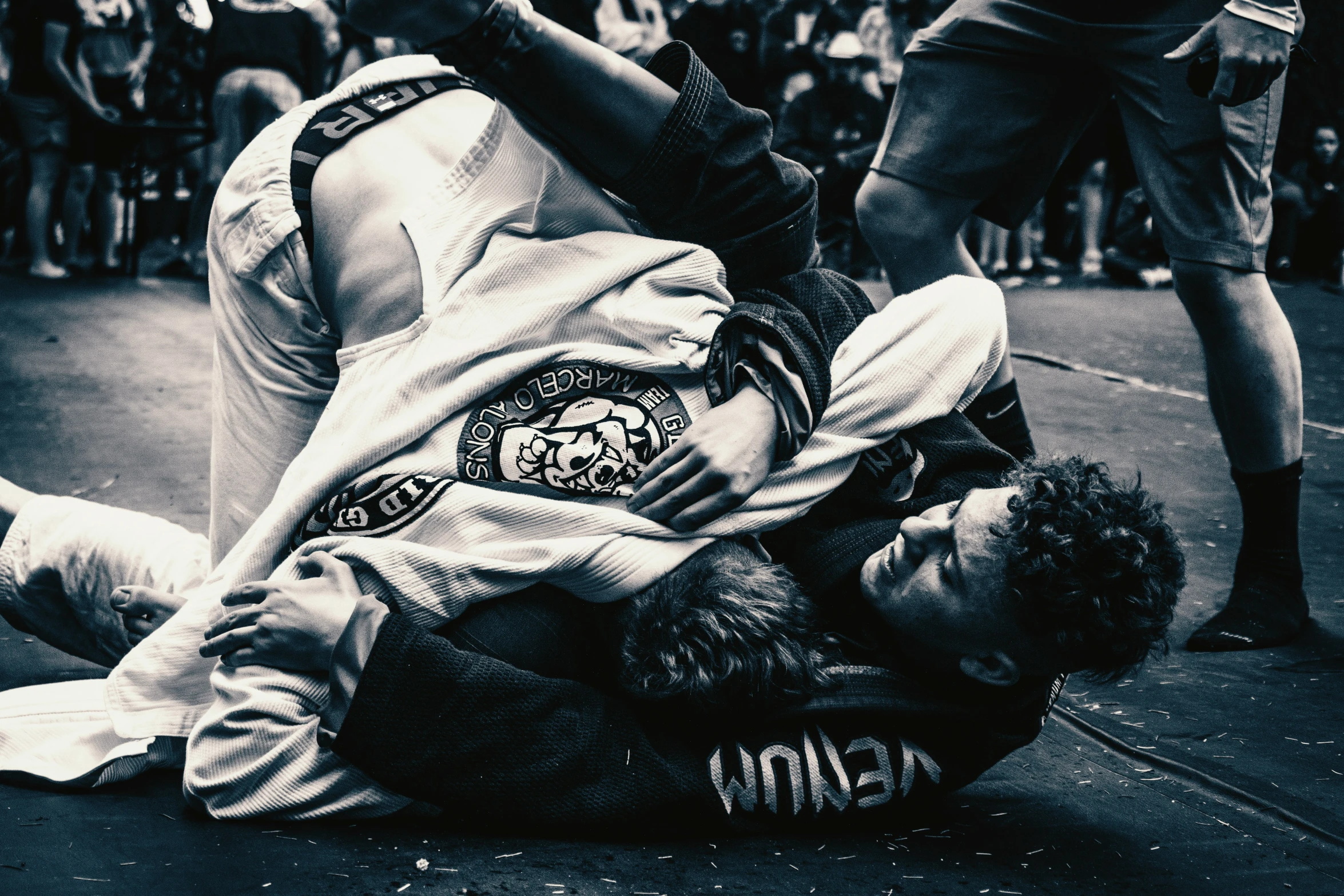 a person laying on the ground with a headlock