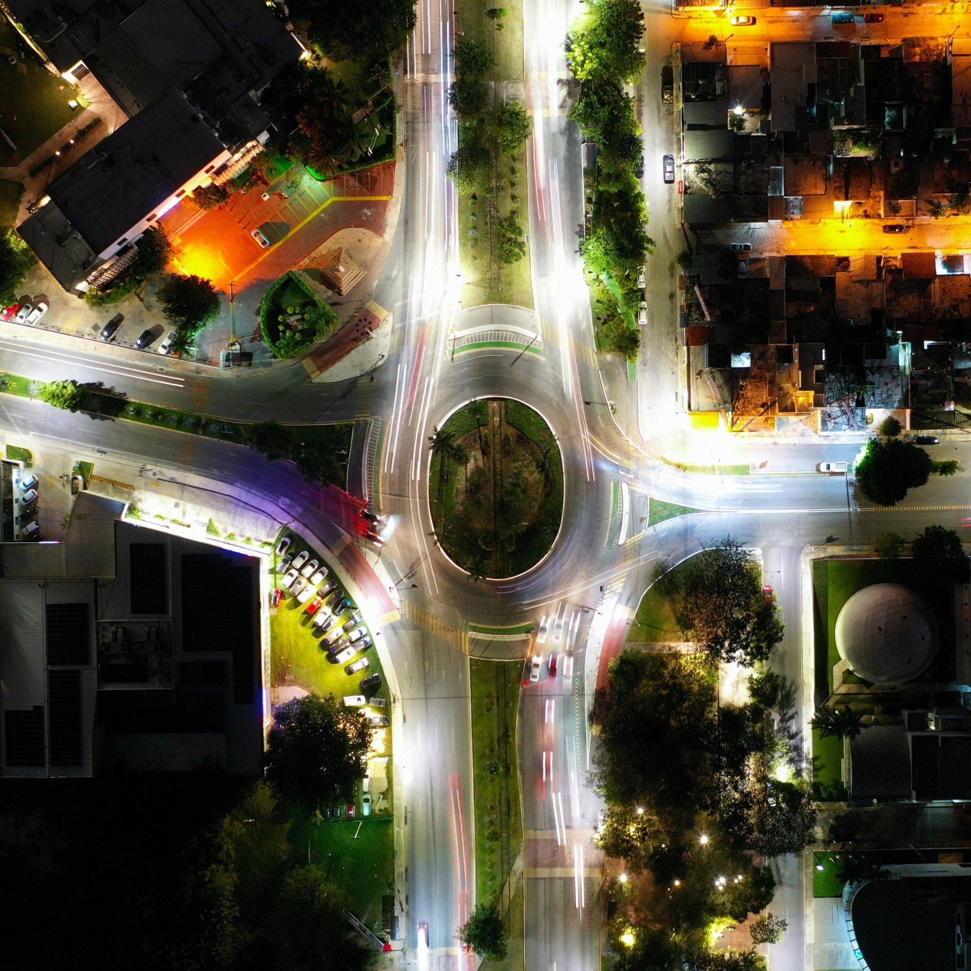 a street intersection at night with various traffic lights on it