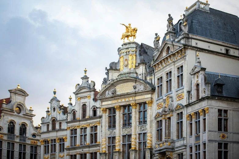 an intricate building with a golden horse and gold decoration