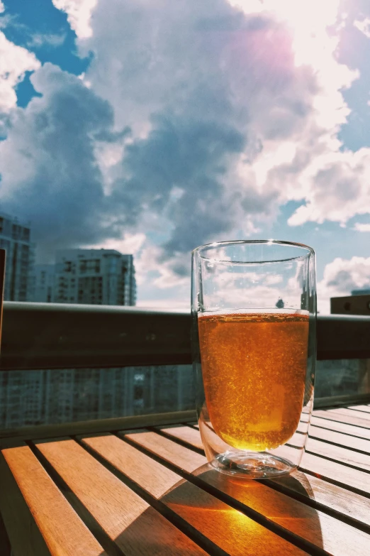 a glass of beer on a wooden table