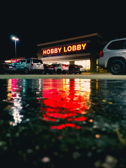 cars parked in front of a holbobb store