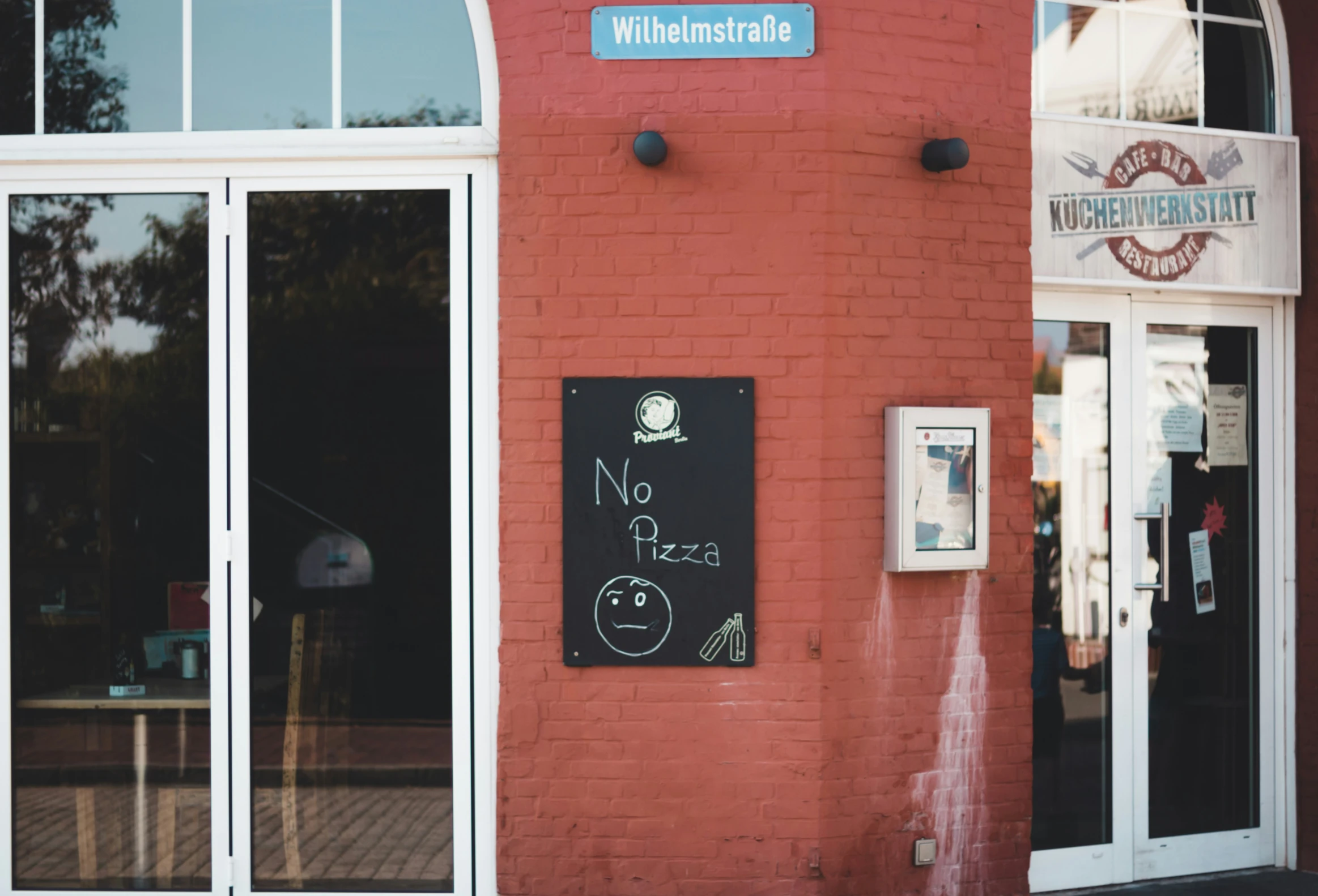 the building has red brick and white doors