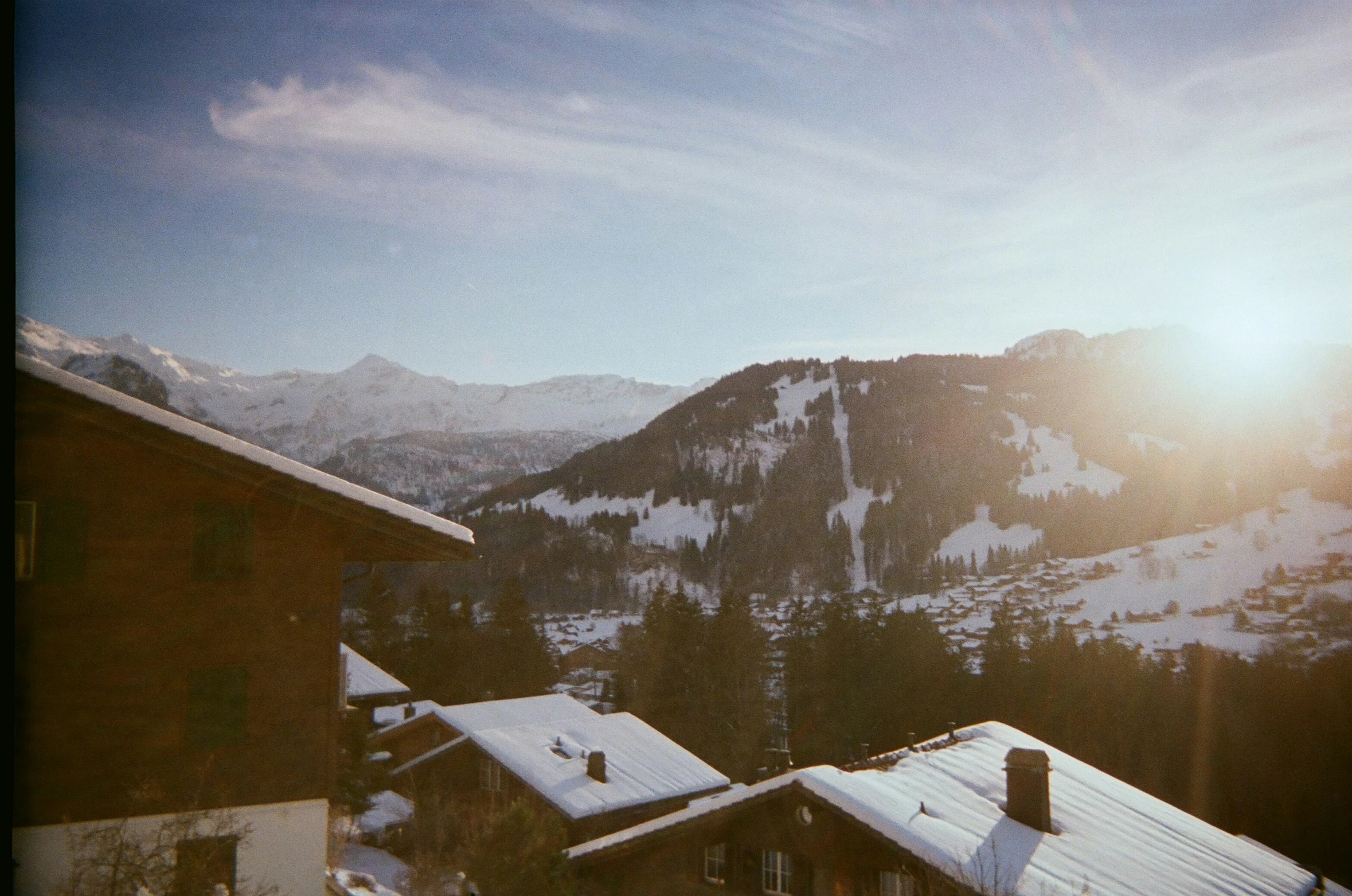 a pair of houses on the mountain with snow