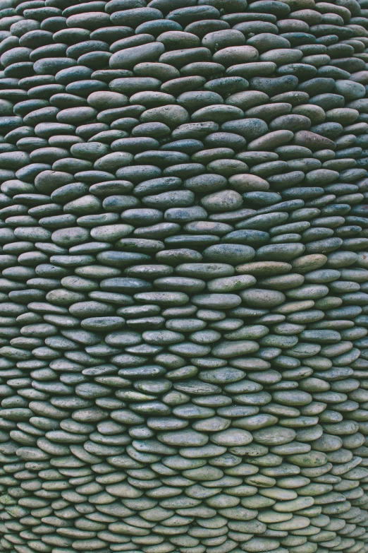 the art sculpture features a green and grey rock