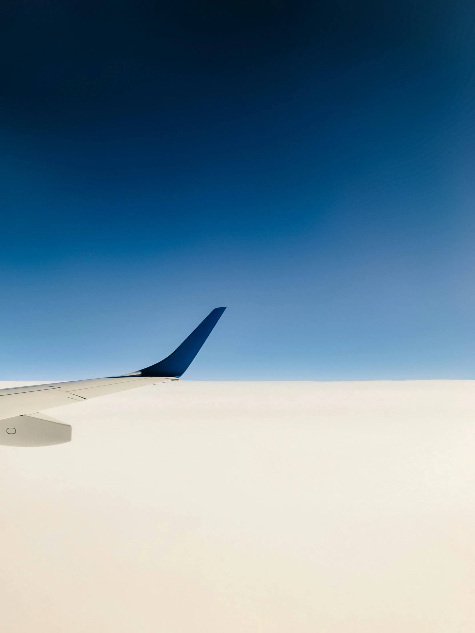 an airplane wing as seen from a very large airplane