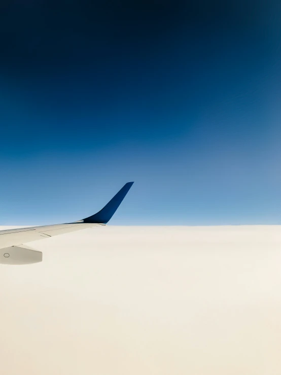 an airplane wing as seen from a very large airplane