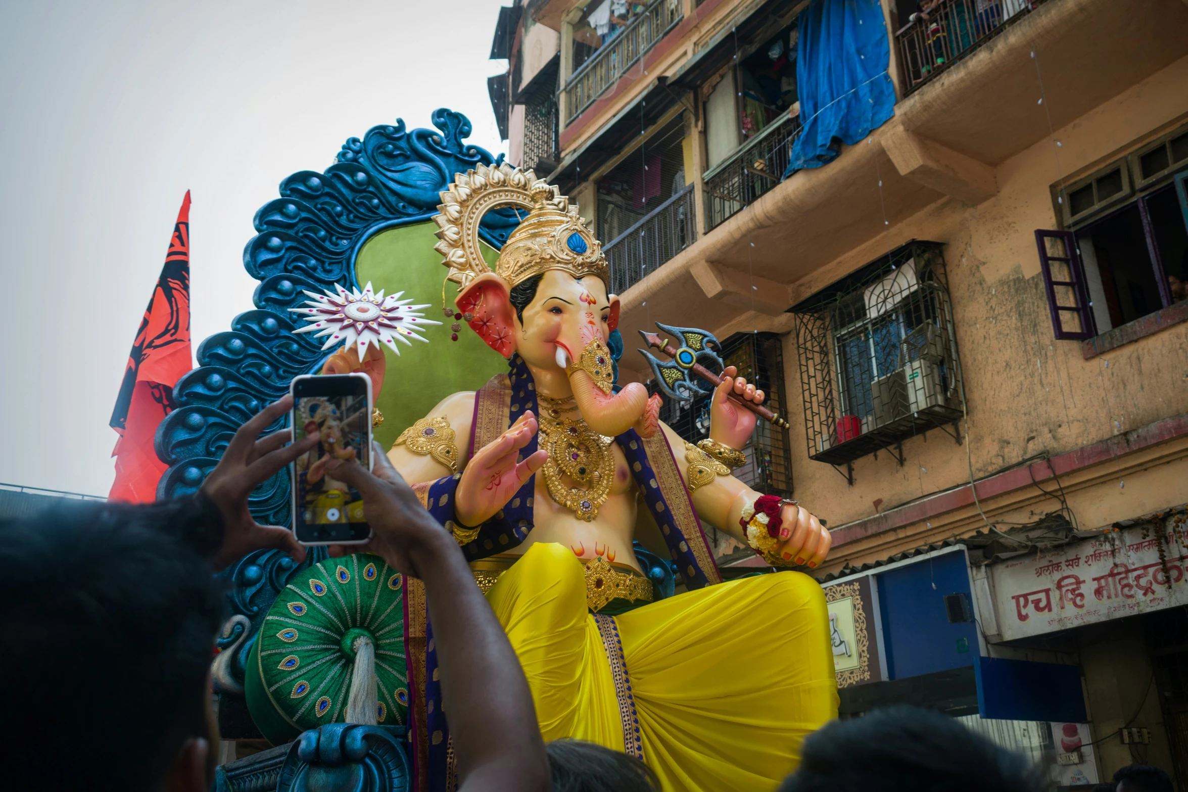 a group of people standing in front of an elephant statue