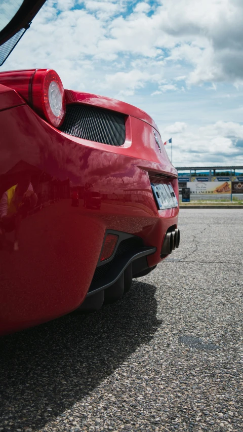 the front bumper and tail of a sports car on asphalt