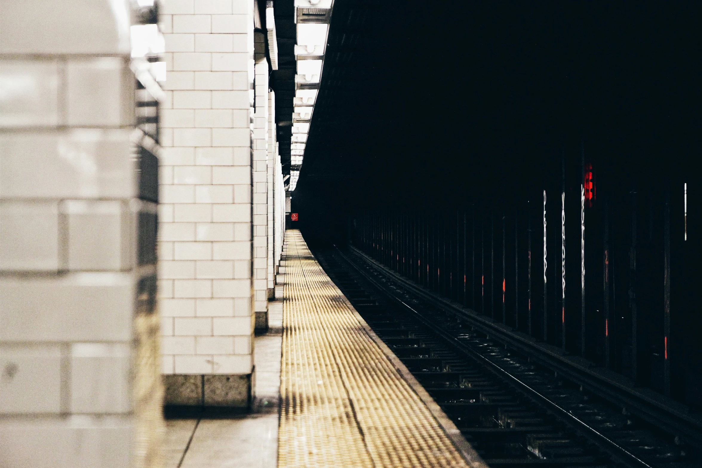 a train track going through a dark tunnel