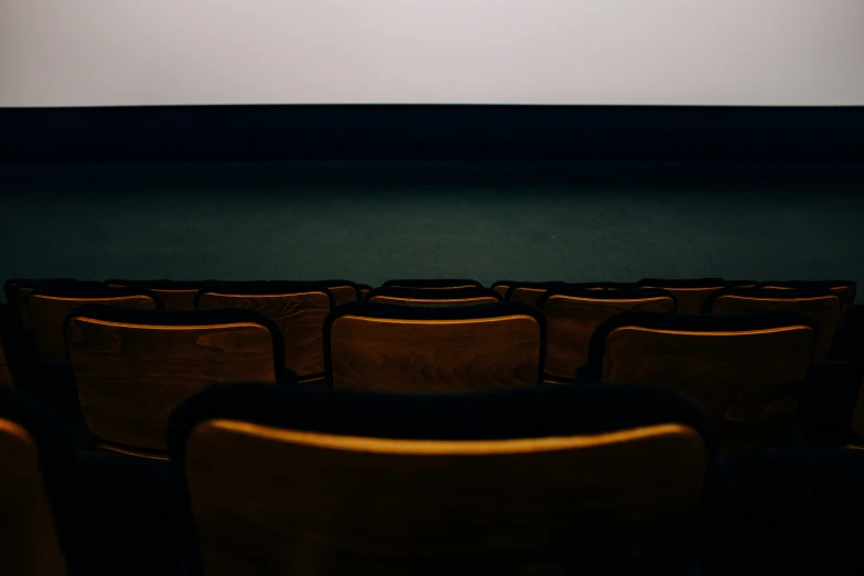 empty theater seats are viewed from far away