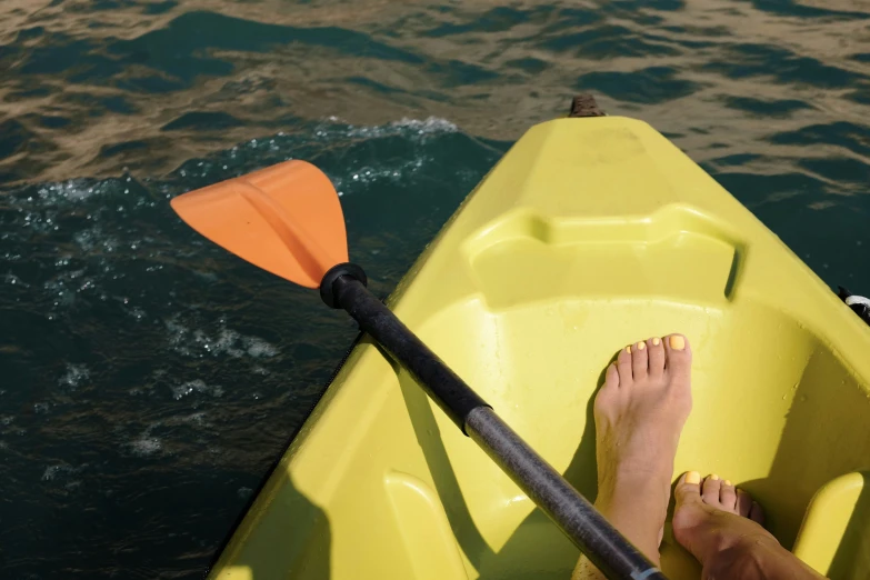 a person who is sitting in a yellow canoe