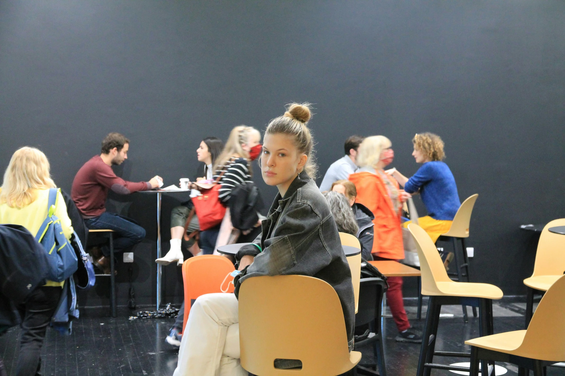 several students sit in chairs, as they study