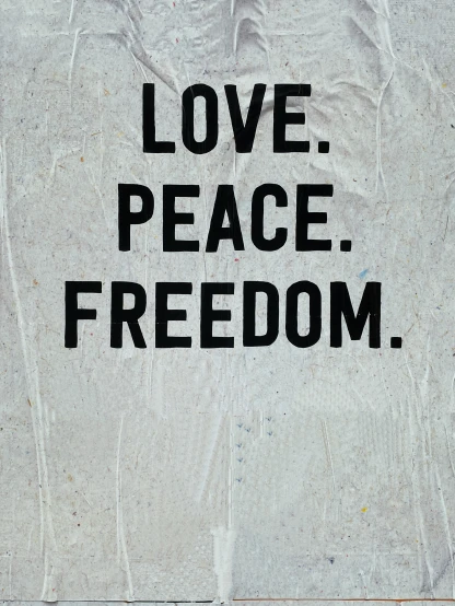 a wall with graffiti written on it and the words love, peace, freedom