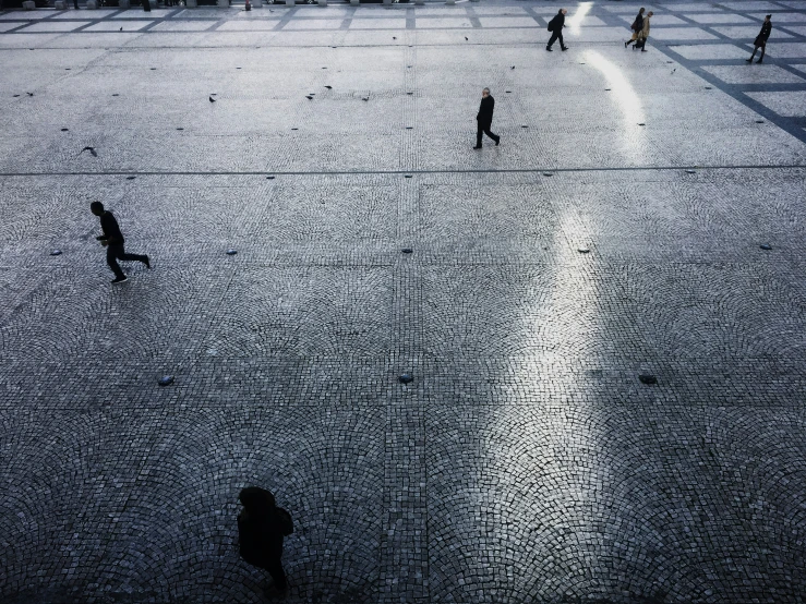 a group of people walking across a field in the rain