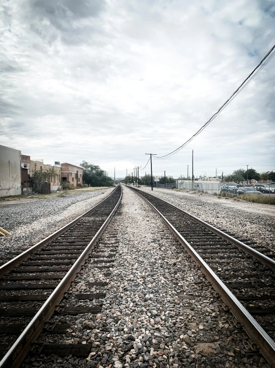 the tracks are empty as an old train pulls into a city