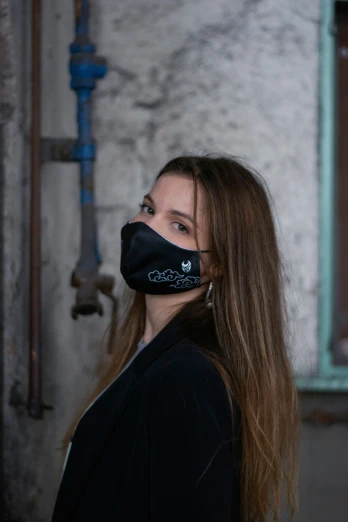 a girl wears a black mask with a skull on it
