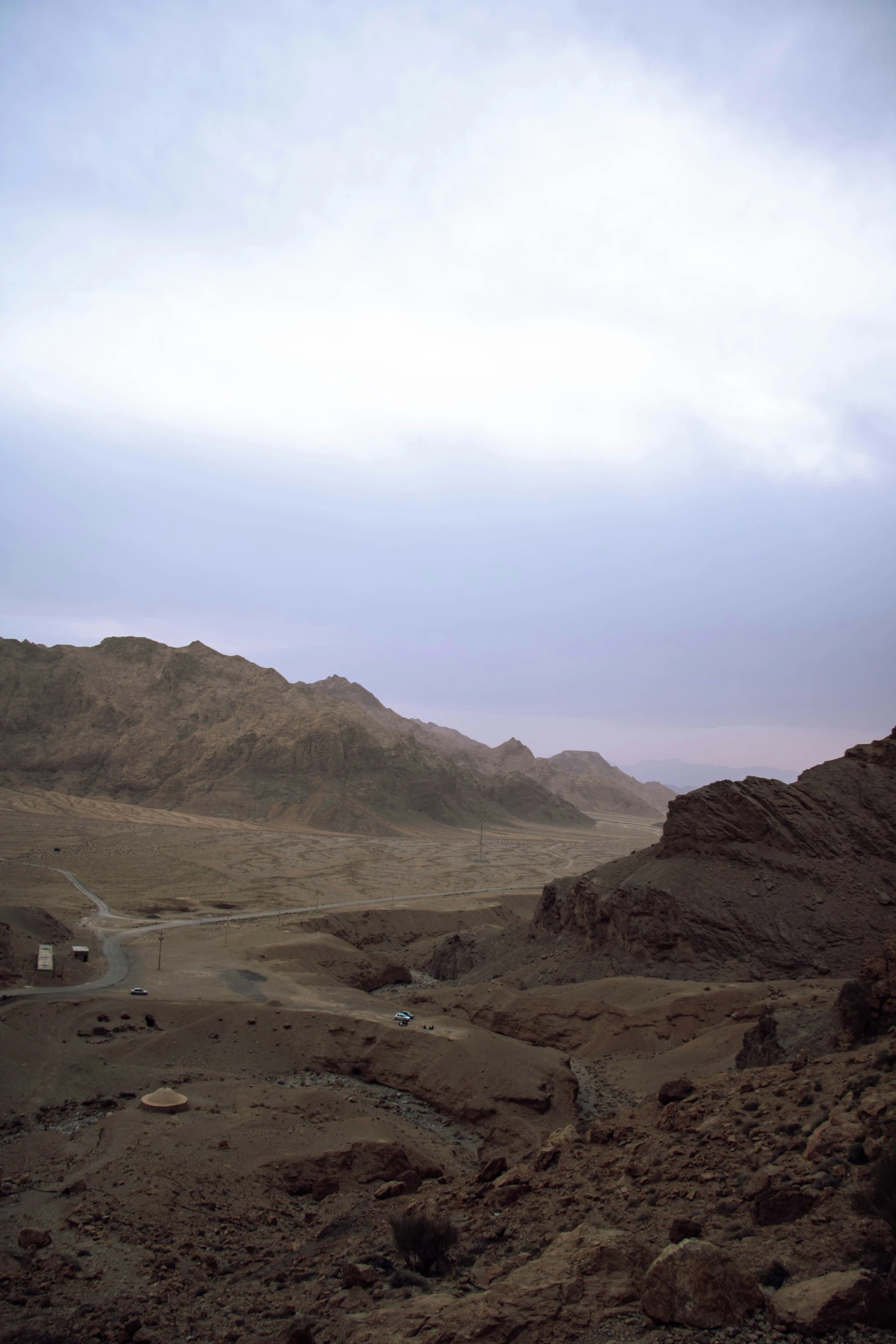 there is a dirt hill and road in the desert