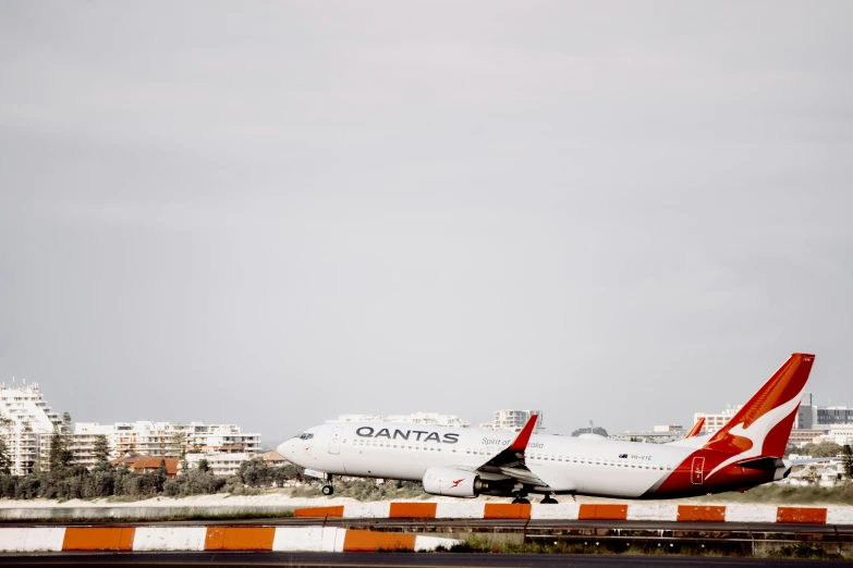 a red and white airplane is on the runway