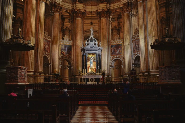 a church that has a large window and some statues on the wall