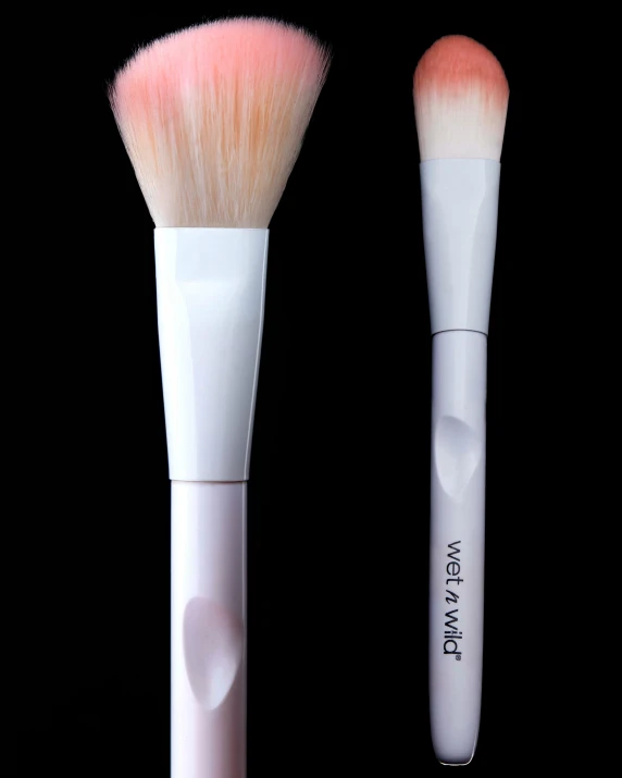 two pink brushes sit side by side on a black background