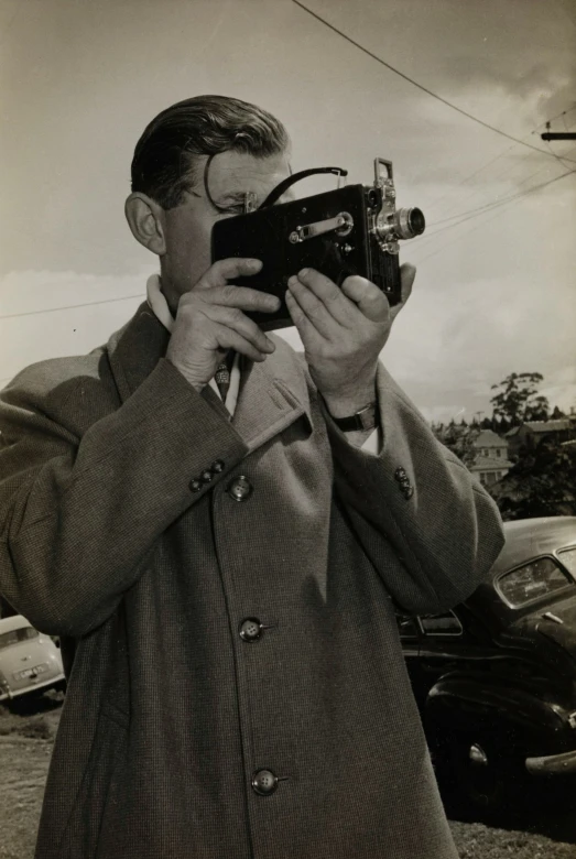 man taking pictures with his old film camera