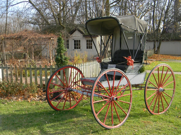 an old cart sitting in the grass outside