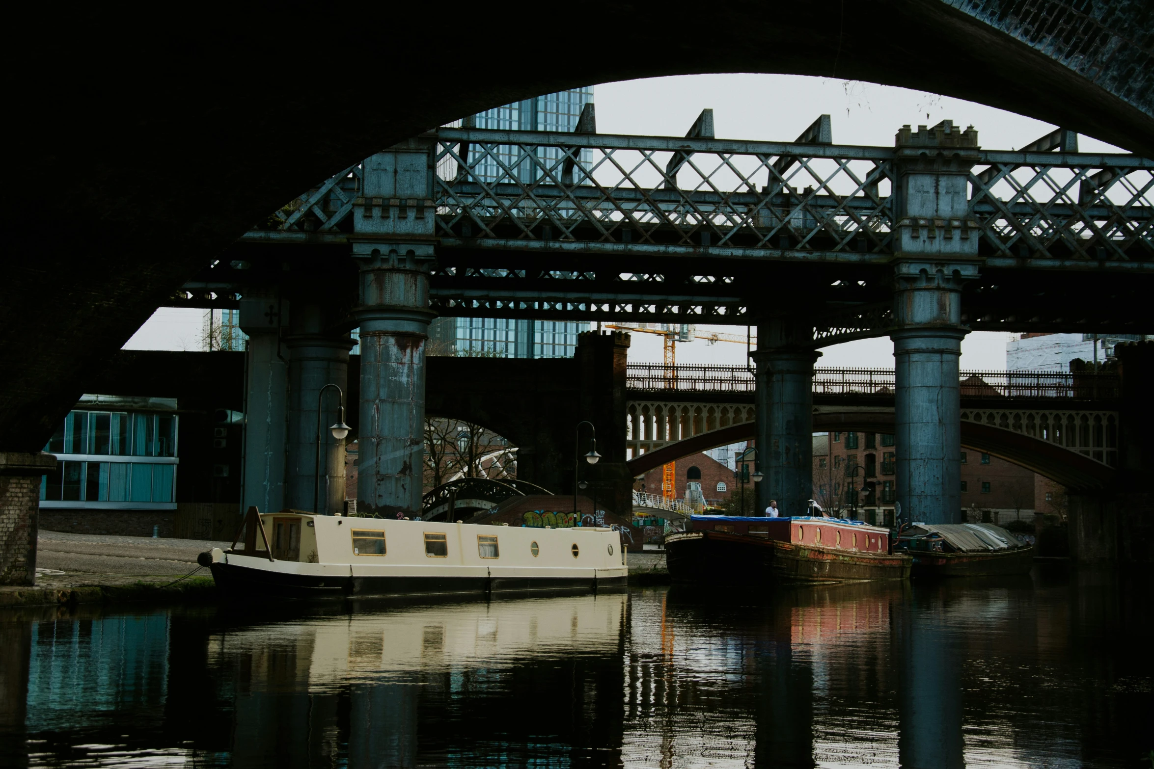 a boat is in the water next to a bridge